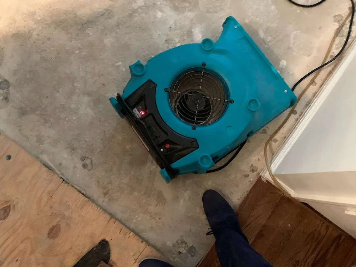 Air mover drying subfloor during Commercial Water Damage Restoration in Fruit Cove